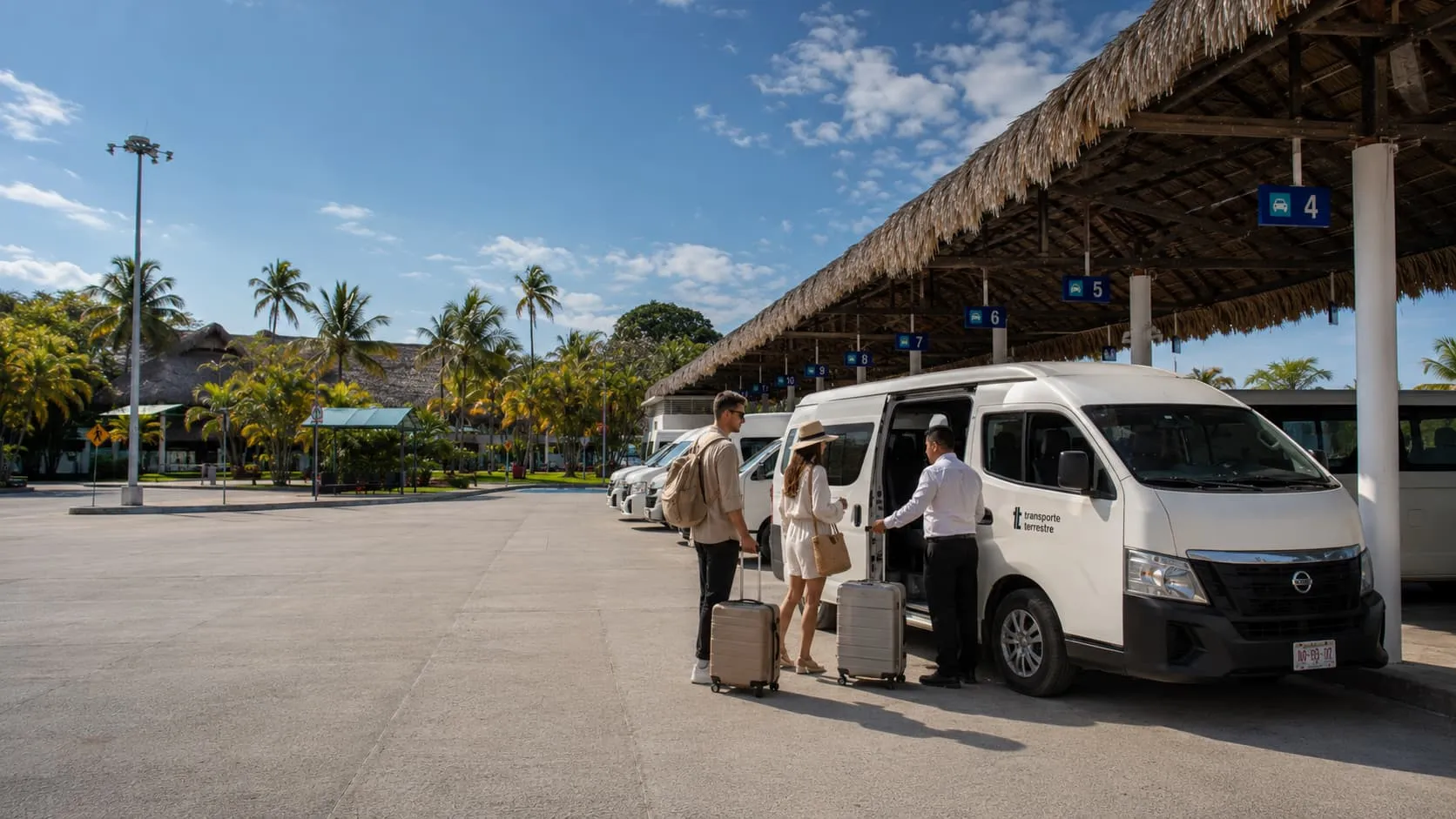 Travelers with luggage boarding an official Transporte Terrestre van at Huatulco Airport